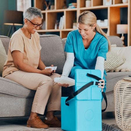 Doctor, senior woman and home with medicine, box or delivery for healthcare, wellness or consulting.