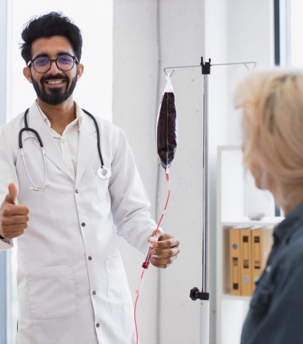 A doctor using an IV bag