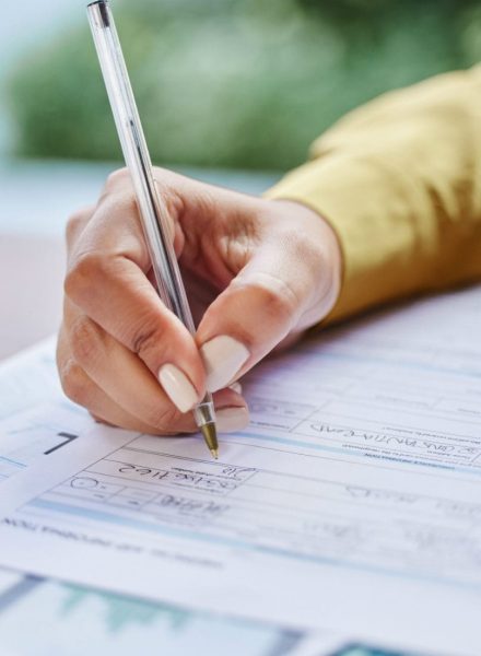 A pen signing a form.