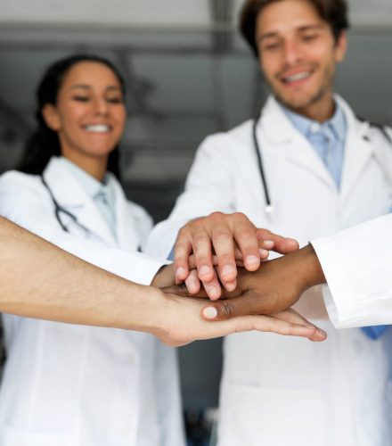 Doctors putting their hands together