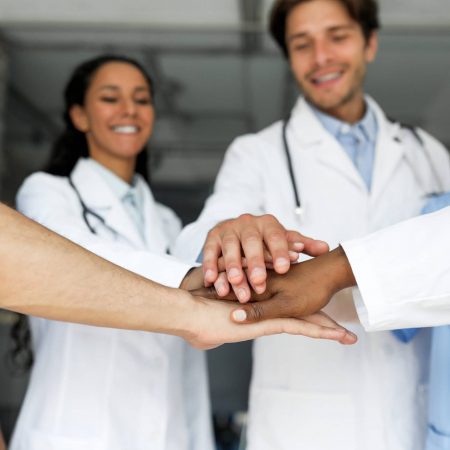 Doctors putting their hands together