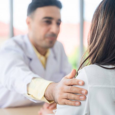 A doctor consoling a patient