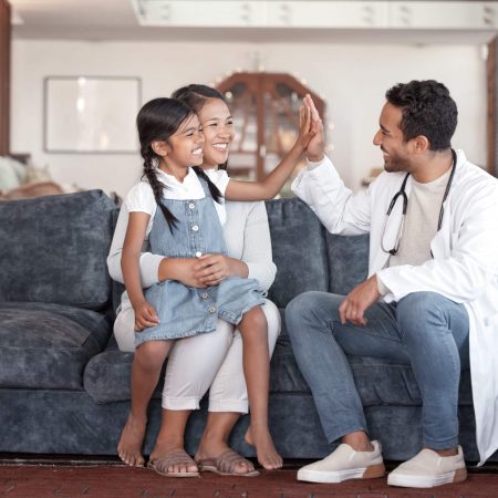 A doctor high-fiving a patient