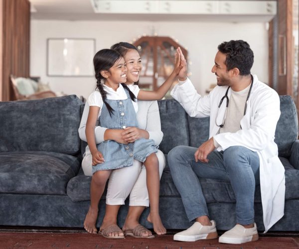 A doctor high-fiving a patient